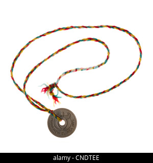 Coin with hole from Papua New Guinea as a necklace; made by a child. Stock Photo