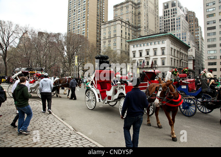 People and crowd gathers in Manhattan, New York City for St. Patrick's Day Parade Stock Photo