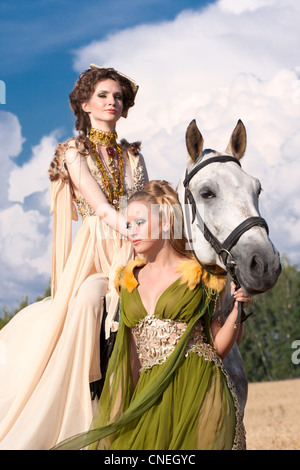 two princess with horse on field Stock Photo