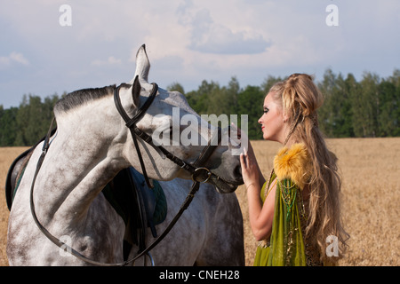 Horse and butiful woman face to face Stock Photo