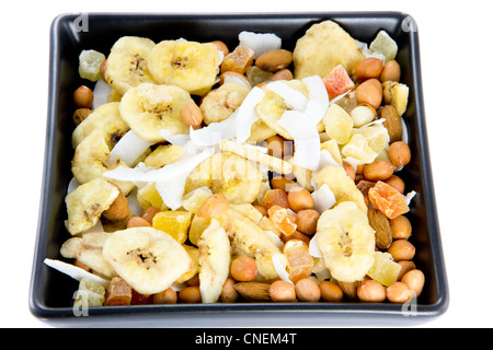 closeup picture of a bunch of nuts and dried fruits together in a black bowl Stock Photo