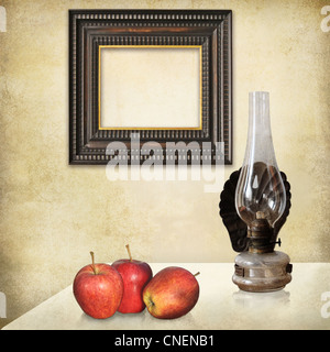 Vintage mockup, art deco empty frame, three red apples, an old oil lamp on a grunge textured interior. Stock Photo