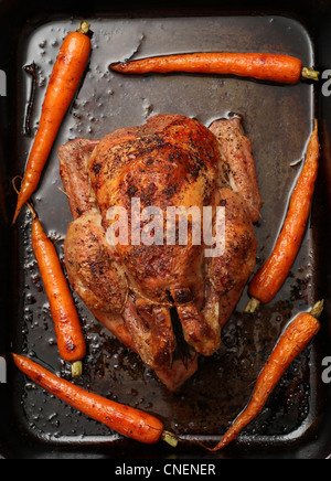 Roasted Free range chicken with roasted carrots. Stock Photo