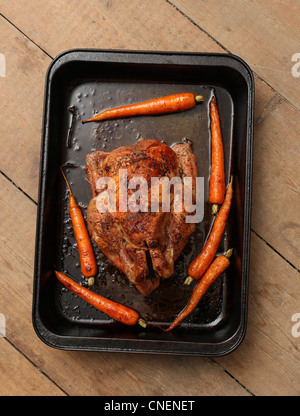 Roasted Free range chicken with roasted carrots. Stock Photo