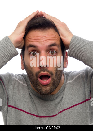 Portrait of a surprised young man with beard looking at camera Stock Photo