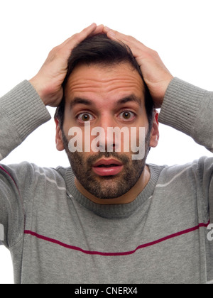 Portrait of a surprised young man with beard looking at camera with hands on his head Stock Photo