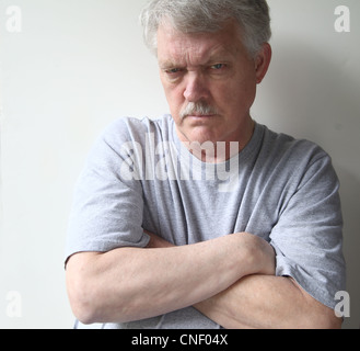 angry older man with his arms crossed Stock Photo
