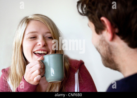 Young man and woman talking over a cup of coffee,, UK Stock Photo