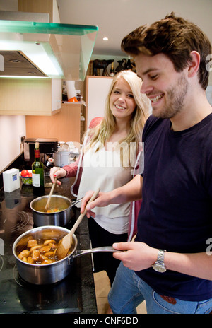 Young couple cooking in the kitchen,  UK Stock Photo