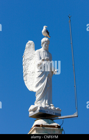 Close up of Angel statue on the top of church tower. Mali Losinj island in Croatia Stock Photo