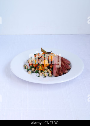 Butternut Squash and chickpea salad with lamb leg staek Stock Photo