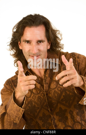 Portrait of gesturing mid aged cheerful, smiling Caucasian male with long hair Stock Photo