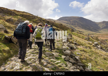 Ramblers group walking along the valley in mountains of Snowdonia National Park. Cwm Eigiau Conwy North Wales UK Britain Stock Photo