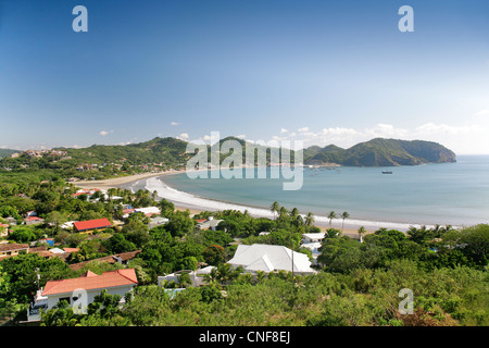 Areal ocean view of bay in San Juan del Sur, Nicaragua, Central America overlooking beach, hills, town and houses sunny day Stock Photo