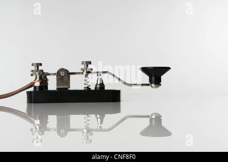 still life image of a morse code key on a white background Stock Photo