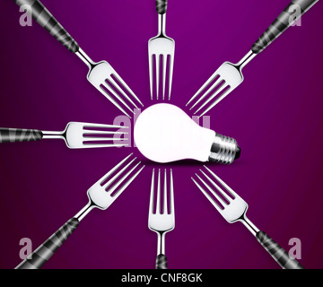 light bulb between forks on purble background. Stock Photo