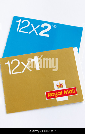 UK, Britain. Books of Royal Mail first and second class postage stamps isolated on a white background Stock Photo