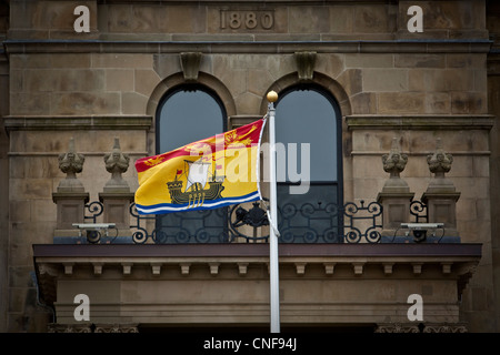 New Brunswick flag flies in front of the Legislative building in Fredericton, New Brunswick Stock Photo