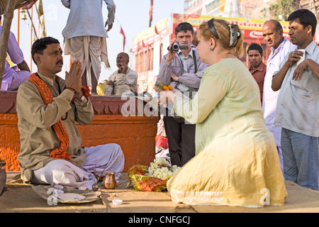 Russian lady praying , Varanasi,India Stock Photo