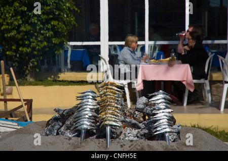 Sardines being grilled in a typical local beach grill Fuengirola city Costa del Sol coast the Malaga region Andalusia Spain Stock Photo