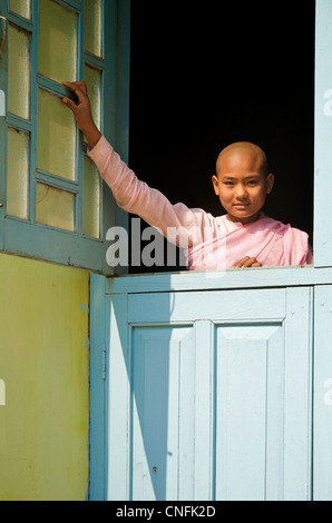 Buddhist nun at the window of a nunnery. Thanboddhay Paya, Monywa, Burma. Myanmar Stock Photo