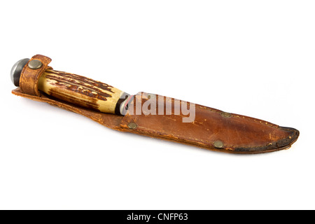 Old bone hunting knife in a leather sheath over white Stock Photo