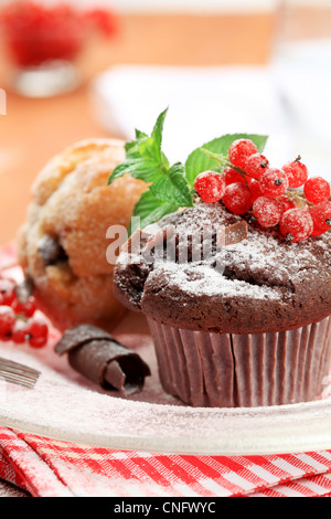 Tasty muffins garnished with fresh red currants Stock Photo