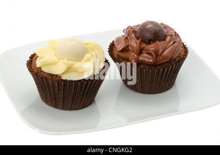 Two chocolate cupcakes served on a white plate - studio shot with a white background Stock Photo