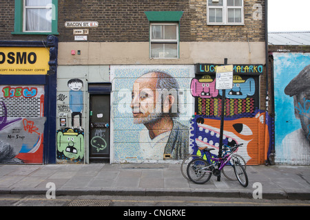 Graffiti covered buildings Bacon Street, off Brick Lane, east London, UK Stock Photo