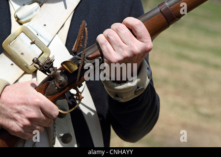 A close-up of a cocked musket rifle during a re-enactment of a United States Continental Army encampment. Morristown, NJ, USA Stock Photo