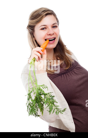 Young beautiful woman eating fresh carrot, isolated on white background. Stock Photo