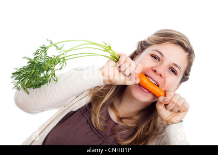 Young beautiful funny woman biting fresh carrot, isolated on white background. Stock Photo