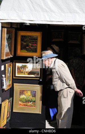 Man checking out paintings at the 2012 Festival of the Arts in New Smyrna Beach, Florida Stock Photo