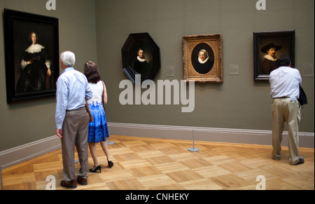 Visitors to the Metropolitan Museum of Art view portrait paintings by Rembrandt van Rijn, 1606-1669. Stock Photo