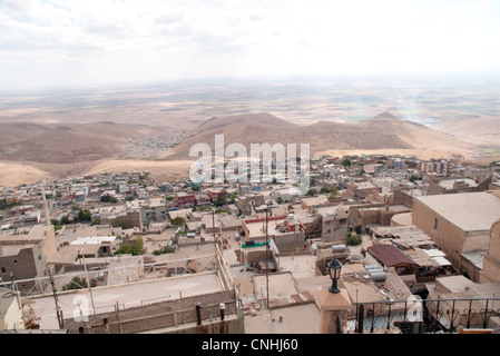 Looking south over rooftops to the Syrian plain from the city of Mardin, in the eastern Anatolia region, southeastern Turkey . Stock Photo