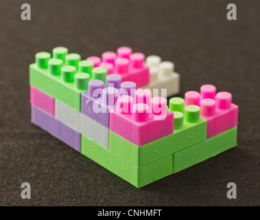 Construction game pieces over a black background Stock Photo
