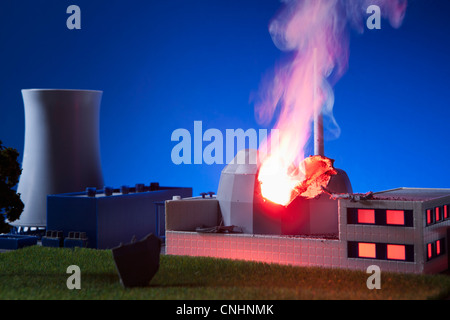 A model built to scale of a nuclear power plant on fire Stock Photo