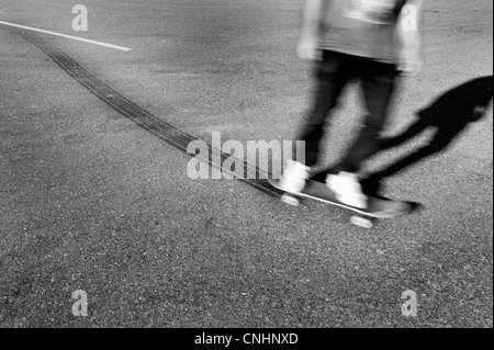 A skateboarder leaving tire tracks Stock Photo