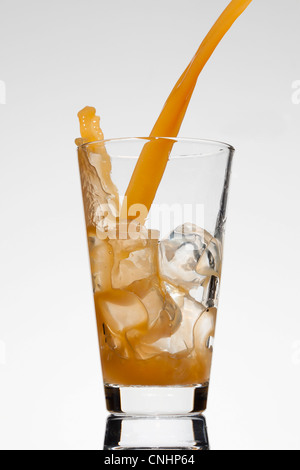 A drink being poured into a glass Stock Photo