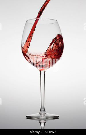 Red wine being poured into a glass Stock Photo