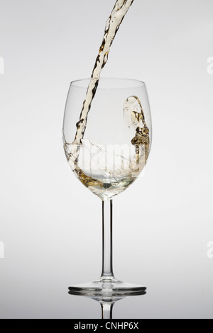 White wine being poured into a glass Stock Photo