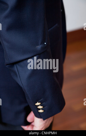 Detail of a pin in the sleeve of a man's suit jacket Stock Photo