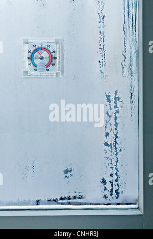 Ice crystals on window and temperature gauge Stock Photo