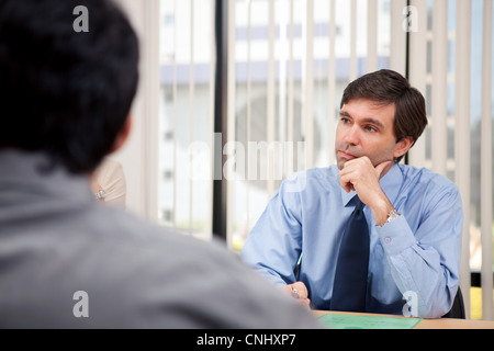 Business executive listening in a meeting Stock Photo