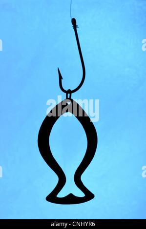 golden fish charm and fishing hook Stock Photo