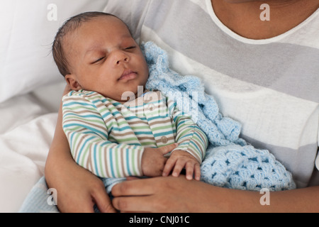 Baby boy in mother's arms Stock Photo