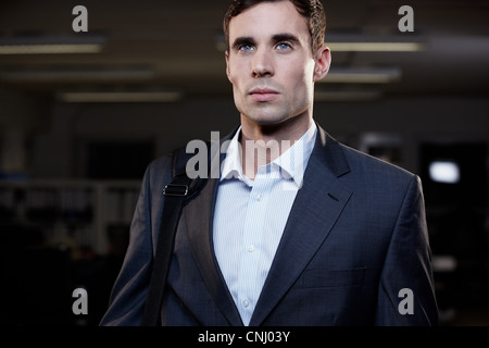 Businessman leaving office in the dark Stock Photo