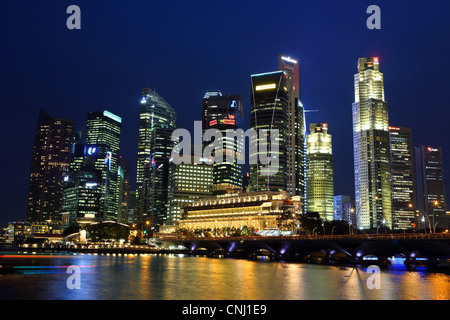 Singapore central business district buildings at dusk in Marina Bay. Stock Photo