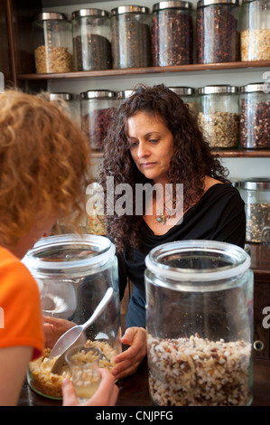 Middle East Israel a chain of spice stores and cafes called Spice Way - a woman sells tea to a shopper Stock Photo