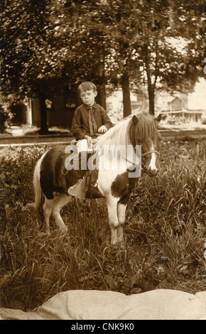 Serious Boy Riding a Shetland Pony Stock Photo